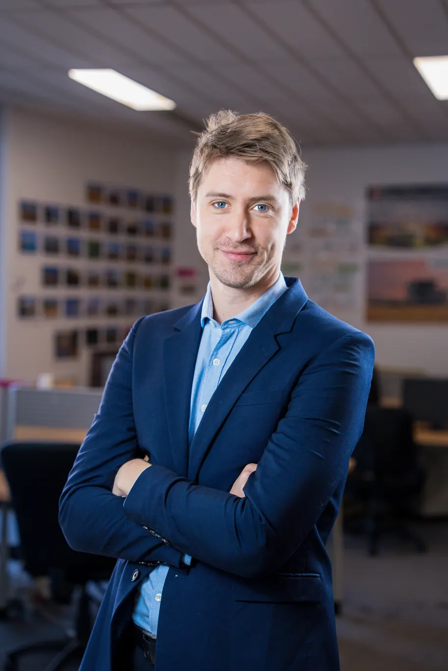 Portrait corporate debout au bureau, bras croisés : collaborateur en costume bleu